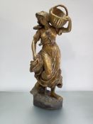 A large late 19th century gilt-plaster figure of a girl, a basket on her left shoulder, unsigned.