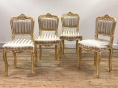 A set of four giltwood side chairs in the Louis XV taste, the shell carved crest rail over back