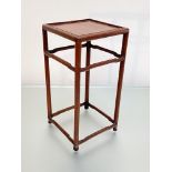 A small Chinese hardwood table stand, the square top raised on circular section legs joined by