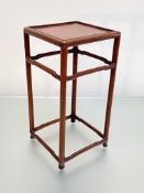 A small Chinese hardwood table stand, the square top raised on circular section legs joined by