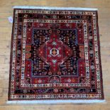 A hand knotted North West Persian rug, of all over geometric design and with multiple guard stripes,