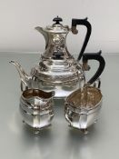 A George V four piece silver tea and coffee service, the coffee pot and cream jug, S.
