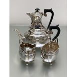 A George V four piece silver tea and coffee service, the coffee pot and cream jug, S.