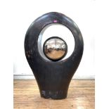 A contemporary Mexican resin floor standing sculpture of ovoid form, the aperture enclosing a