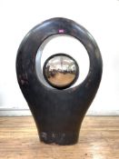 A contemporary Mexican resin floor standing sculpture of ovoid form, the aperture enclosing a