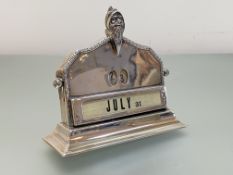 An Edwardian silver perpetual desk calendar, Elkington & Co., Birmingham 1910, of shaped arched