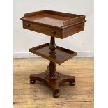 A Victorian mahogany side table, of unusual form, the three quarter galleried top above a frieze