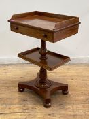 A Victorian mahogany side table, of unusual form, the three quarter galleried top above a frieze