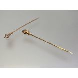 Two single stone diamond stick pins, c. 1900, each mounted in yellow metal (unmarked) as a claw