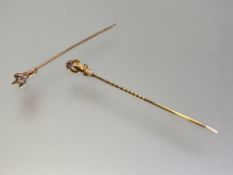 Two single stone diamond stick pins, c. 1900, each mounted in yellow metal (unmarked) as a claw