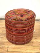A modern stool of cylindrical form, upholstered in Kilim type fabric, H46cm, D49cm