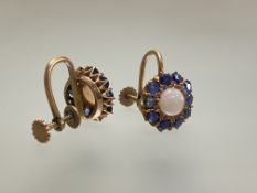 A pair of opal and sapphire earrings, the round-cut central opal within a band of claw-set round-cut