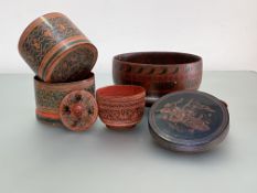 A group of Burmese lacquered containers, early 20th century comprising: a betel box, the flat lift-