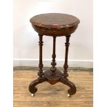 A Victorian figured walnut work table, the circular boxwood-strung top lifting to reveal satinwood-