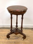 A Victorian figured walnut work table, the circular boxwood-strung top lifting to reveal satinwood-
