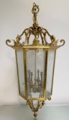 A large gilt-brass hall lantern, the tapering hexagonal frame inset with six bevelled glass panels