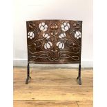 An early 20th century Art Nouveau period hammered copper fire screen, decorated with embossed and