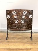 An early 20th century Art Nouveau period hammered copper fire screen, decorated with embossed and