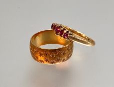 An 18ct gold wedding band, engraved with a pattern of stars; together with a five stone garnet ring,