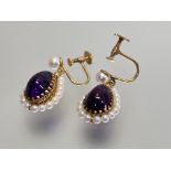 A pair of amethyst and seed pearl drop earrings, each pear-cut amethyst within a band of seed