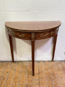 A Continental gilt-metal mounted kingwood demilune fold over card table, the rosewood crossbanded
