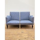 A striking pair of upholstered corner chairs, in a blue brocade fabric, enriched with brass stud