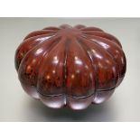 A red lacquered pumpkin-form box and cover, probably Japanese. 12cm by 21cm