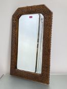A stamped leather wall mirror in the Arts & Crafts taste, the frame decorated with a Celtic Knot