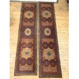 A pair of hand knotted Mamlouk design runner rugs, in reds, blues and ivory, of all of stylised