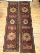 A pair of hand knotted Mamlouk design runner rugs, in reds, blues and ivory, of all of stylised