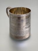 A Victorian silver christening mug, Henry Holland, London 1869, of tapering cylindrical form,