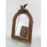 A carved walnut and parcel-gilt arched frame, now incorporating a mirror plate, 19th century, the