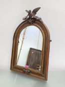 A carved walnut and parcel-gilt arched frame, now incorporating a mirror plate, 19th century, the