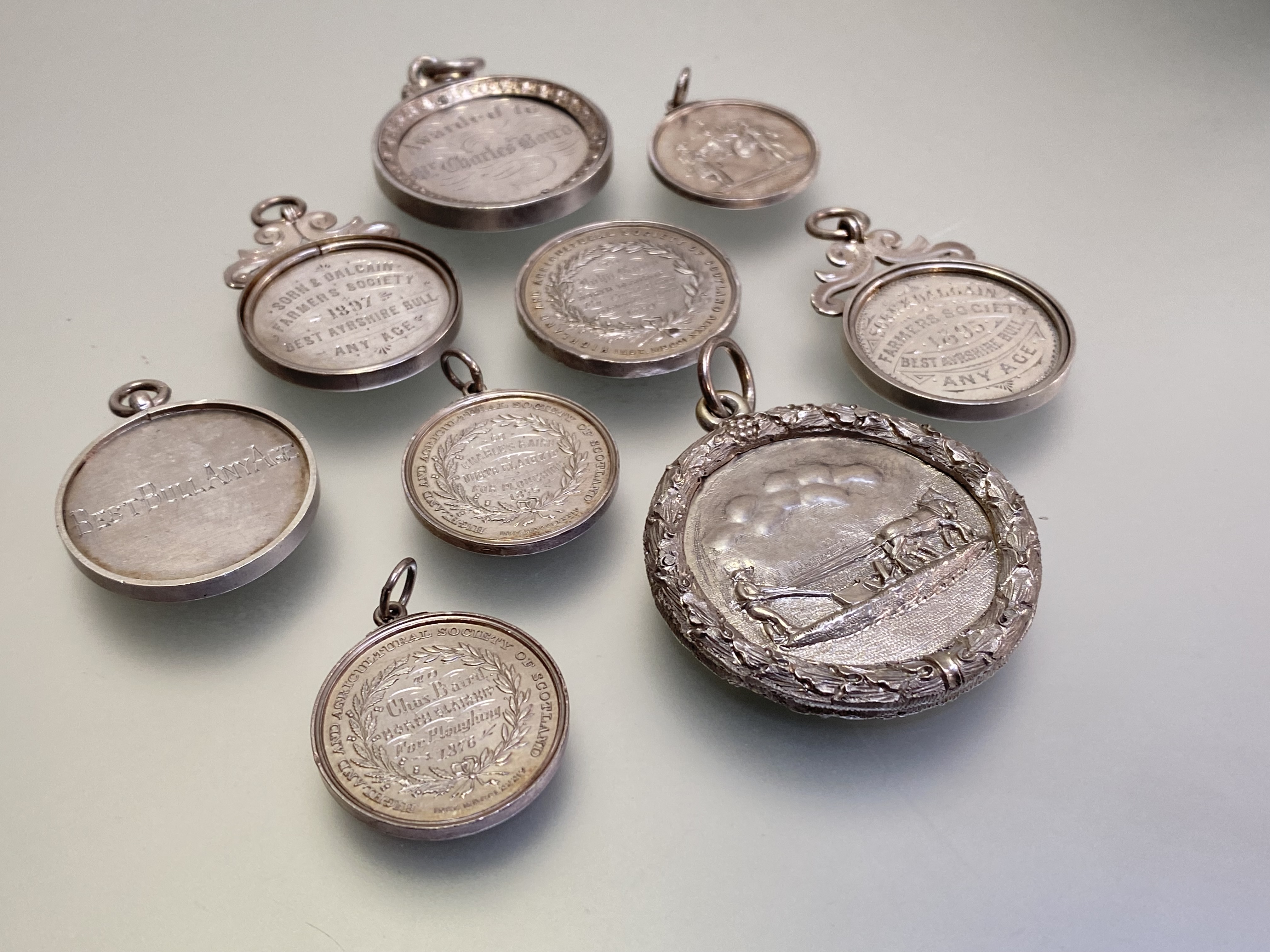 A group of late 19th century silver and white metal agricultural medals and fobs, the largest from