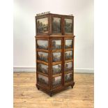 A striking mahogany music cabinet, c. 1900, enriched with numerous painted landscape and other