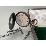 A late 19th century yellow-metal mounted gun metal half hunter pocket watch, the white enamel dial