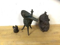 A small African bronze decorate mask possibly Baule, cast with bulging eyes and elaborate headdress,