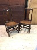 A 19thc pair of vernacular oak oak chairs, shaped crest rail over trophy shaped splat plank seat,