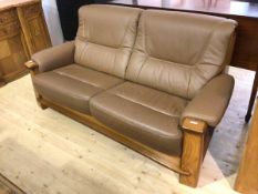 A modern sofa with oak frame upholstered in chocolate brown leather, measures 93cm x 193cm x 80cm