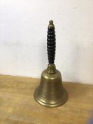A 19thc brass school bell with ribbed wooden handle, measures 29cm high