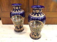 A pair of Royal Limoges baluster shaped vases with gilt and enamel decoration on blue ground, both