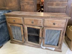 A hardwood side cabinet the rectangular top over three short drawers, each above a grilled door,