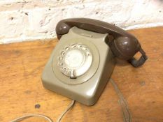 A vintage telephone with rotary dial, measures 12cm high