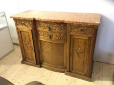 An early 20thc continental inverted break centre bow front credenza, the marble top over four