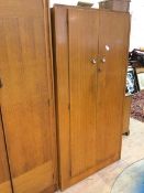 A mid century two door wardrobe interior with shelf and hanging space, on plinth base, measures