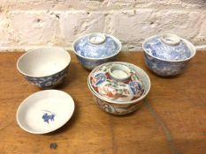 A group of four Chinese rice bowls and covers, three blue and white, one polychrome, all measure