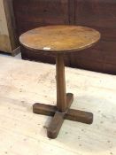 A 19thc country oak occasional table, the circular top raised on a tapering octagonal column and a