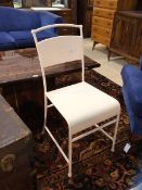 A white painted metal side chair, measures 88cm x 42cm x 43cm