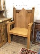 An oak monumental gothic style throne chair with arched back over rectangular seat on straight