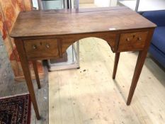 A Georgian mahogany kneehole side table the rectangular top with rounded edges and overhang to